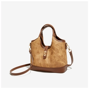 Detail view of vintage bucket bag with embossed swan pattern and gold metal buckle