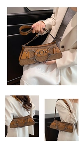 Close-up of brown woven handbag featuring vintage metal ring and adjustable leather strap