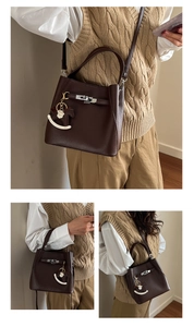 Detail of dark brown lychee grain leather bucket bag with silver buckle and pony charm