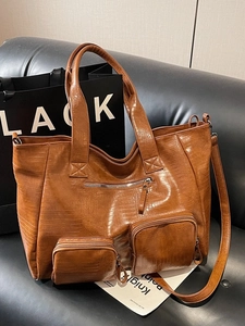 Brown large capacity tote bag in crocodile texture with multi-pocket moto style