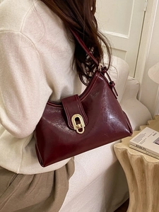 Minimalist burgundy patent leather shoulder bag with gold oval clasp for women