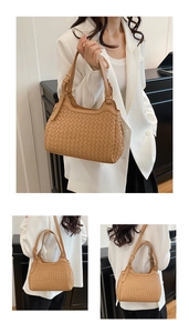 Detail of brown woven hobo bag showing intricate Intrecciato texture and adjustable strap