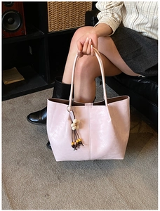 Détail du grand sac cabas rose avec breloque fleurie en perles et texture mate