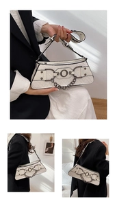 Detail of white woven trapezoid bag with dark metal rings and adjustable wide strap