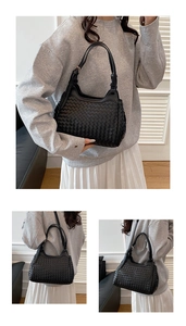 Detailed close-up showing the woven leather texture and adjustable strap of the black bucket bag