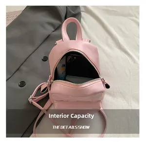 Detailed interior view of pink quilted mini backpack showing storage capacity for items