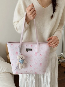 Pink cartoon bear tote bag with a white plush teddy bear pendant and slim shoulder straps
