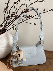 Light blue faux leather shoulder bag with woven strap and cute plush bear charm