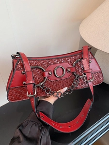 Chic burgundy woven baguette bag with metal rings and chain straps in vintage style
