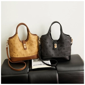 Close-up of retro bucket bags showing embossed logo patterns and metal lock details