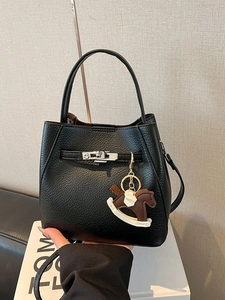 Chic black litchi leather bucket bag with silver buckle and iconic horse charm accessory