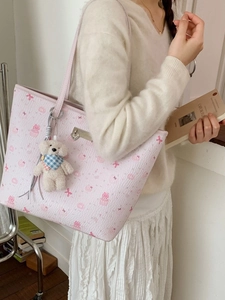 Pink cartoon bear print tote bag with plush charm and stylish faux leather texture