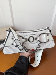 White woven baguette bag with chain detail and adjustable strap shown in hand