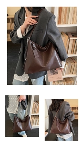Detail of vintage dark brown faux leather tote bag with shoulder strap in a library setting
