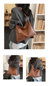 Detail of a brown large capacity Hobo shoulder bag with leather tag and metal buckle