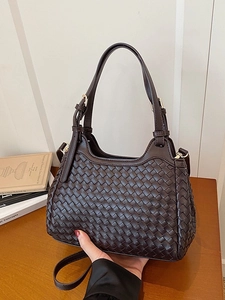Dark brown woven leather bucket bag with top handle and adjustable shoulder strap