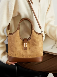 Retro monogram canvas bucket bag with brown leather trim and gold metal lock