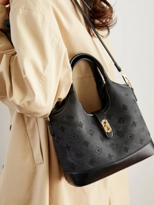 Vintage jacquard canvas bucket bag with black leather trim and gold metal hardware
