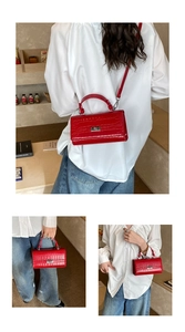 Detail showing the red crocodile embossed texture and silver twist lock on this Kelly bag