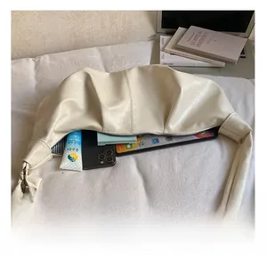 Detailed interior of white pleated hobo bag showing large storage for tablet and phone