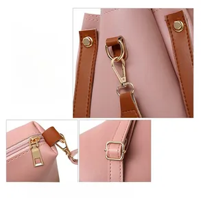 Dettaglio ravvicinato della borsa in pelle rosa chiaro con hardware dorato e cuciture robuste