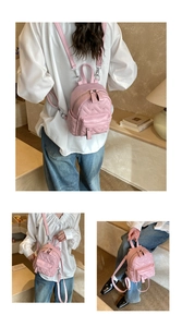 Detail of pink quilted mini backpack showing heart patterns and versatile strap options