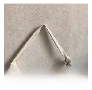 Detail of creamy white pleated tote bag showing knot strap and metal zipper closure