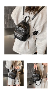 Close-up of black quilted mini backpack featuring silver zippers and adjustable straps