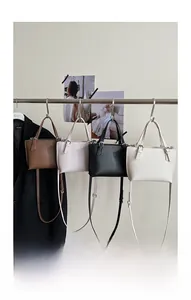 Detailed display of four leather crossbody bags in brown, pink, black and beige colors