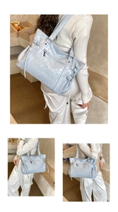 Detail view of light blue tote bag with ruched faux leather and zip pocket detail