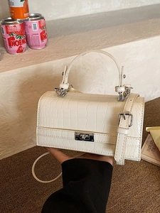 Chic cream crocodile pattern structured handbag with silver metal twist lock and strap