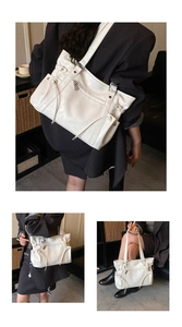 Detailed view of white large capacity tote bag with multi-pocket design and soft PU leather