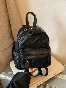 Versatile black quilted leather mini backpack with heart pattern for travel and leisure