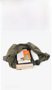 Capacity display of the army green canvas tote bag with books and daily essentials