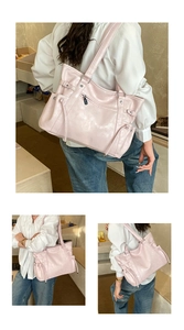 Detail of pink leather tote bag featuring side drawstring accents and exterior zipper pocket
