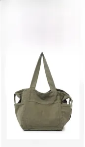 Front view of army green canvas tote bag featuring multi-pocket design and double handles