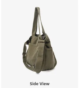 Detail view showing side pockets and thick canvas material of the army green tote bag