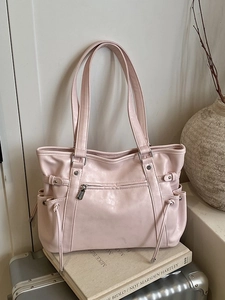 Pink large capacity faux leather tote bag with silver zippers and side drawstring detail