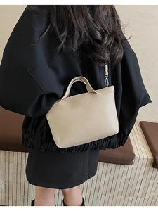 Beige faux leather crossbody bag shown on model for a casual commuter style look