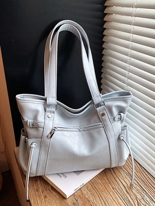Light blue PU leather tote bag with large capacity and dual handles in natural sunlight