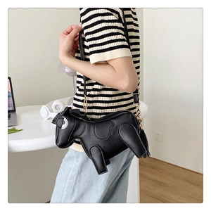 Detail view of horse shaped crossbody bag with lychee texture leather and tassel
