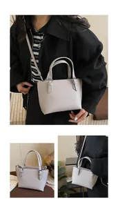 Detail view of a lavender pebble leather tote bag with silver metal buckles and straps
