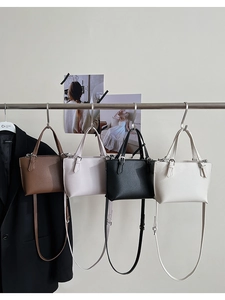 Row of textured leather square handbags in brown, pink, black, and beige colors