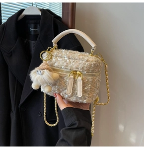 Close-up of tweed crossbody bag featuring silver sequins and cute monster charm detail