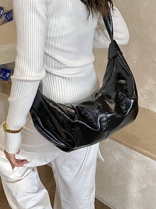 Glossy black patent leather slouchy crescent hobo bag with wide shoulder strap
