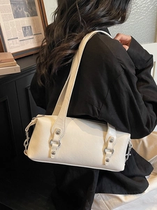 Chic off-white underarm baguette bag with silver ring detail and dual straps for women