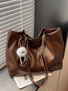 Fashionable dark brown large tote bag with gold chain strap and white pompom charm