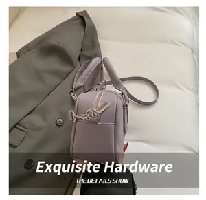 Detail of light purple leather bowling bag showing silver zippers and detachable strap