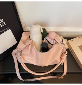 Large capacity pale pink crescent bag showing spacious interior with daily essentials