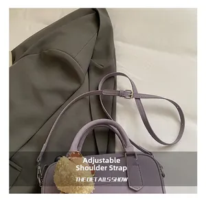 Détail du sac bowling lavande avec bandoulière réglable et boucle métallique